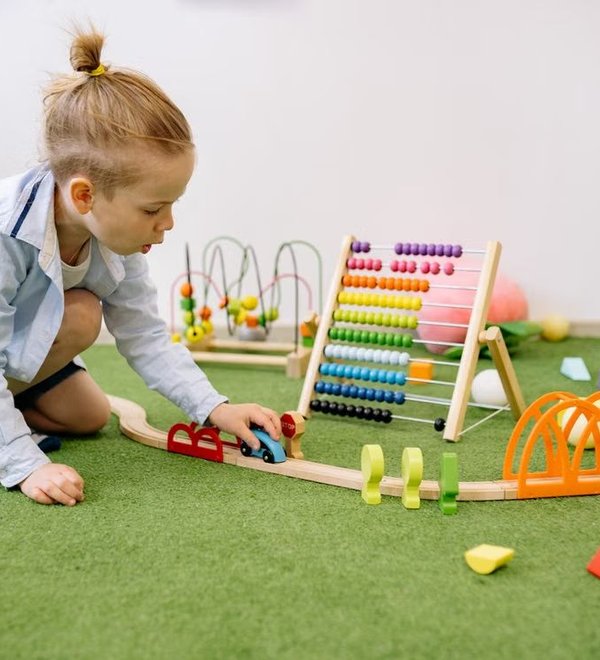 Preschool children building together with colorful blocks